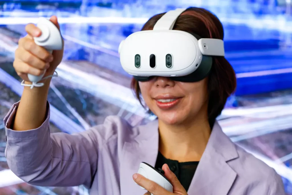 UCLA assistant professor Cindy Anh Nguyen — who works in the new Digital Humanities department as well as the Department of Information Sciences — uses a Meta virtual reality headset. (Ronaldo Bolaños / Los Angeles Times)